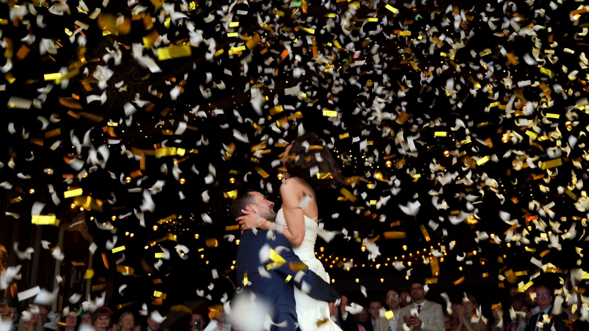 the signature confetti moment during the first dance as the groom lifts his bride up during the first dance at Wharfedale Grange