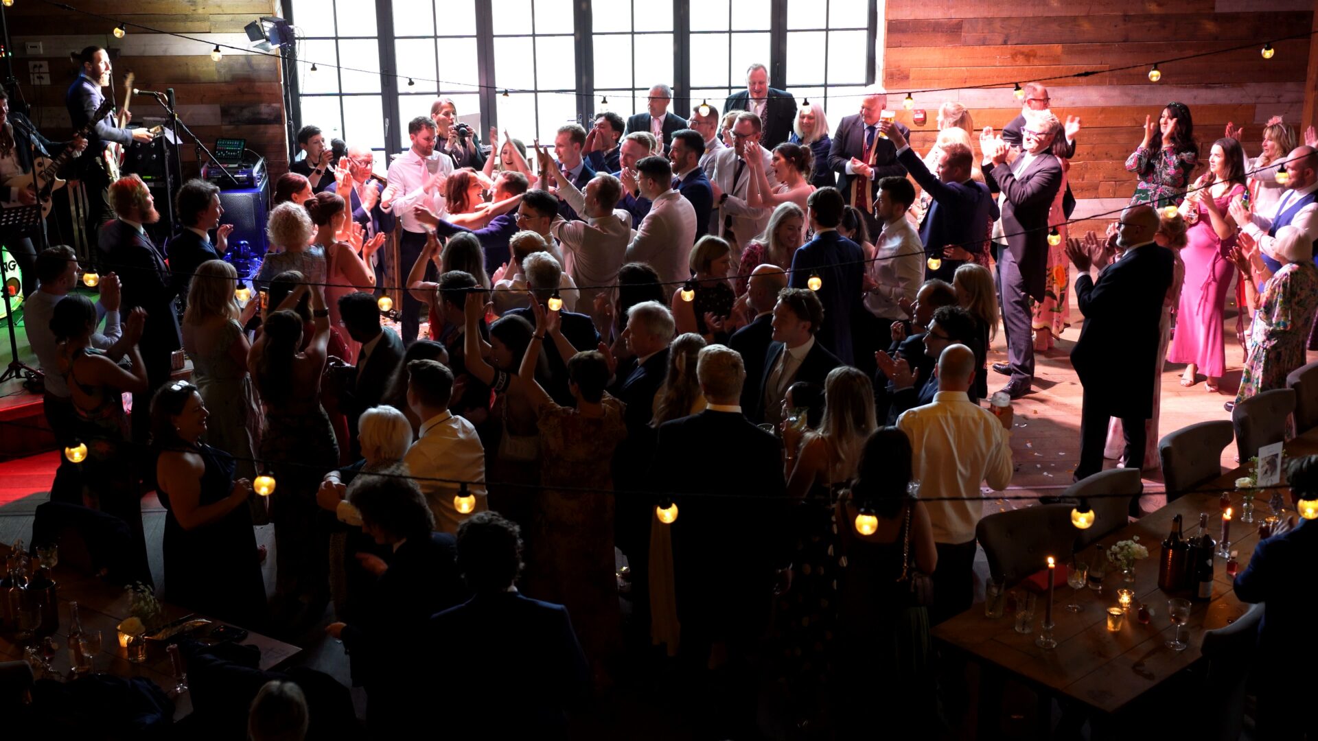 Guests fill the floor as the Warning Tones wedding band perform Indie floorfillers at a wedding in Wharfedale Grange