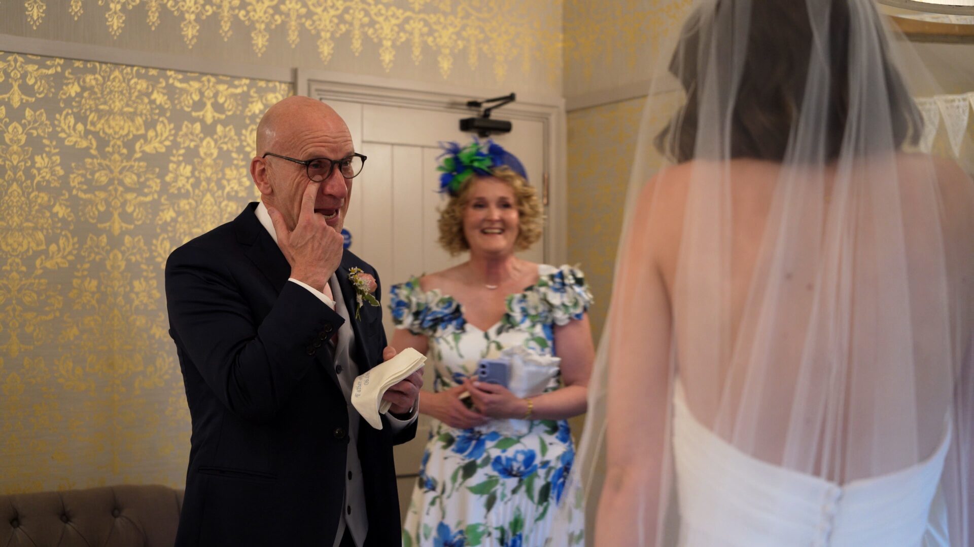 a father of the bride wipes away a tear during a relaxed wedding morning at Wharfedale Grange