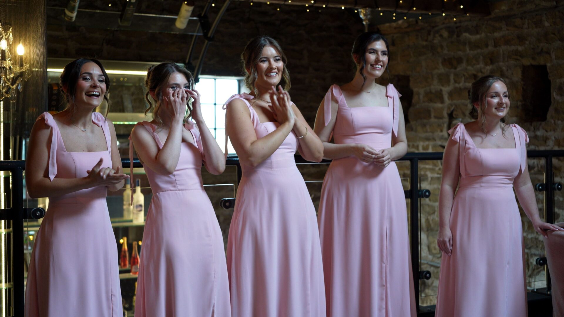 Candid documentary style wedding videography of bridesmaids first look before heading to the wedding ceremony wearing blush pink bridesmaid dresses
