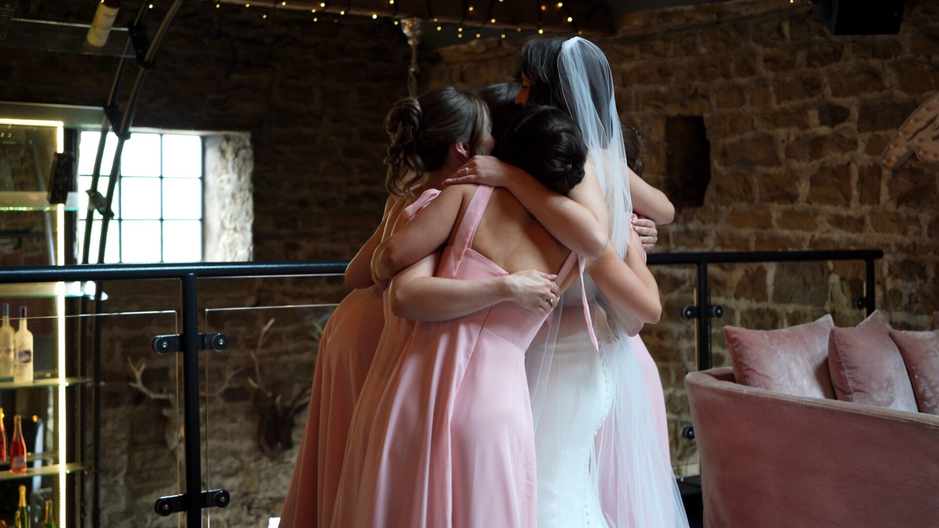a candid moment caught on video of the bride and bridesmaids hugging at Wharfedale Grange