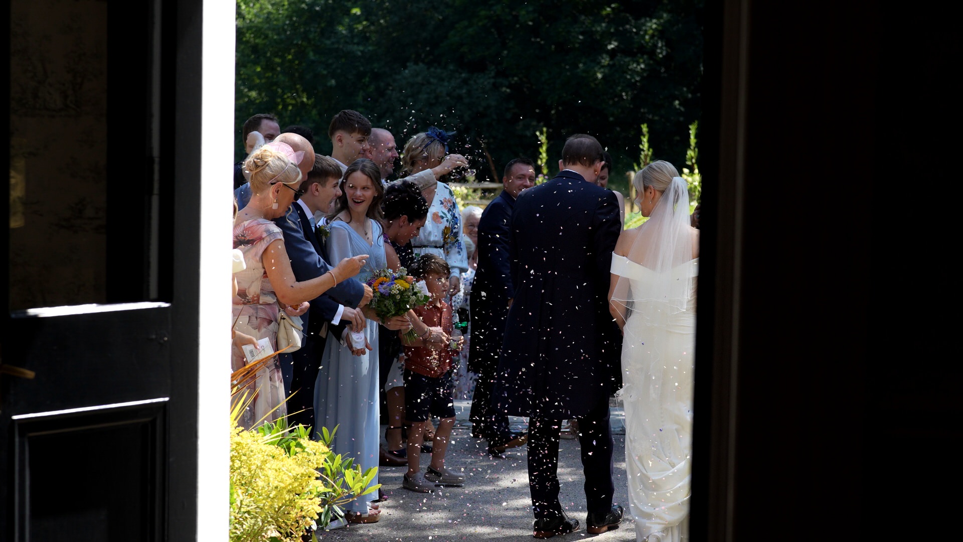 a more unique shot from the videographer filming the confetti outside Ashfield House