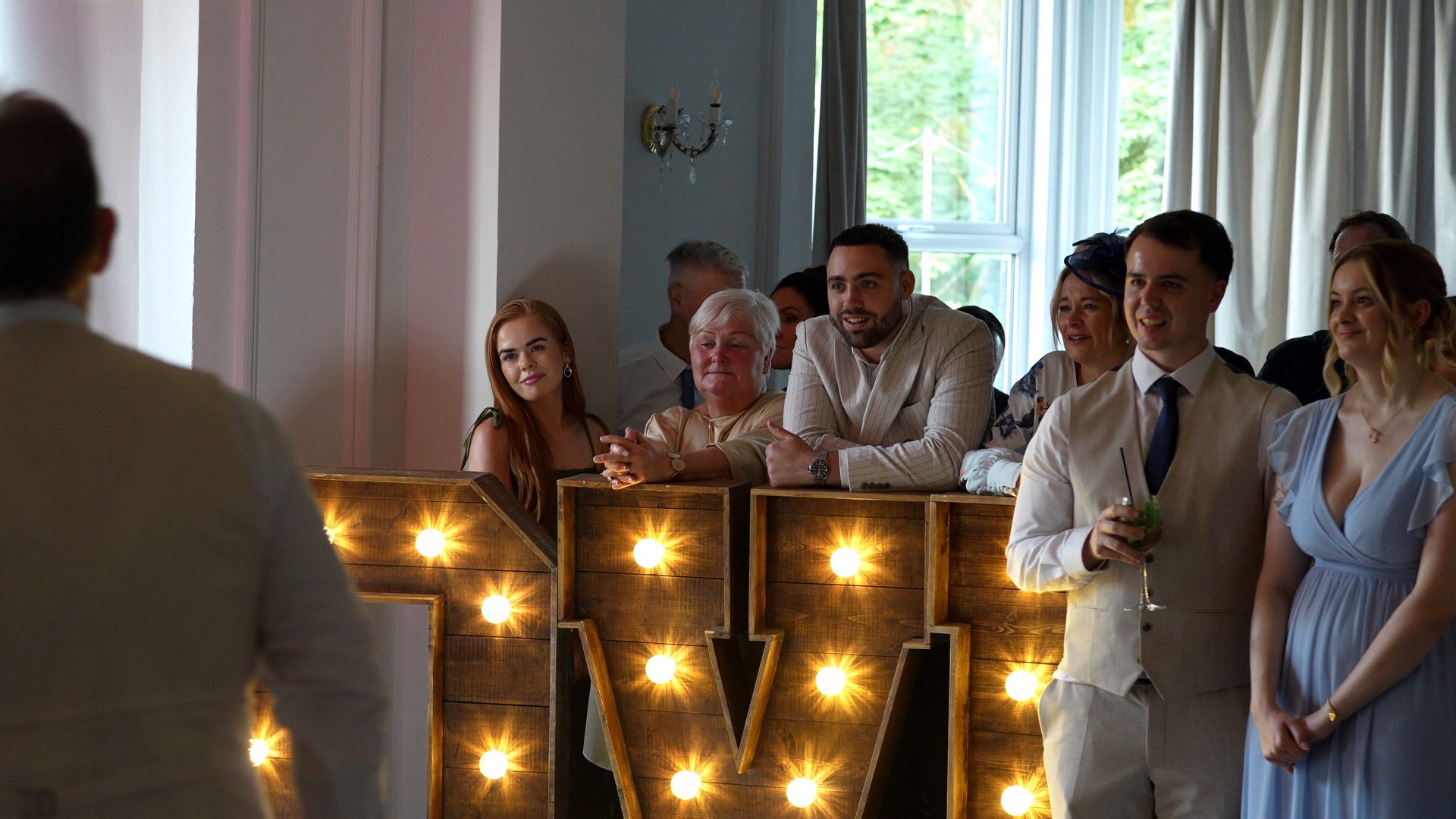 guests watch their first dance leaning on LOVE letters at Ashfield House