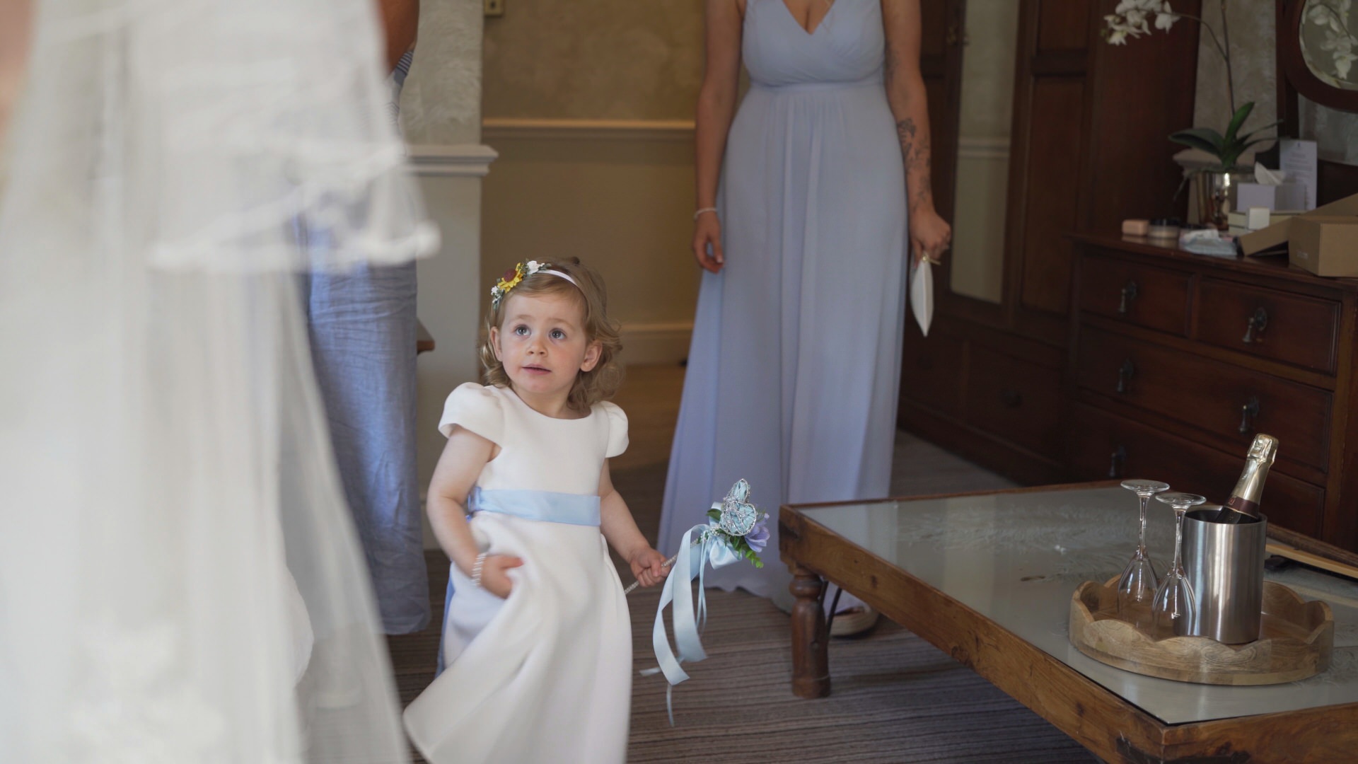a flower girl looks up at the bride