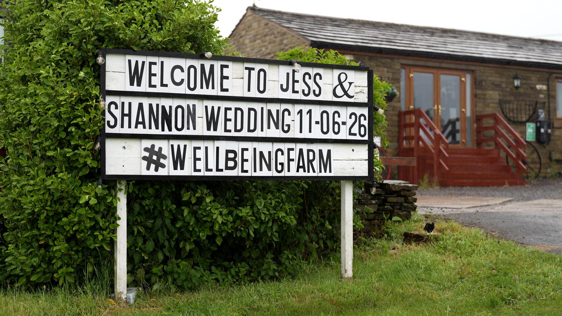 a cinema style sign outside the wellbeing farm in Bolton Lancashire shows the brides names and wedding date