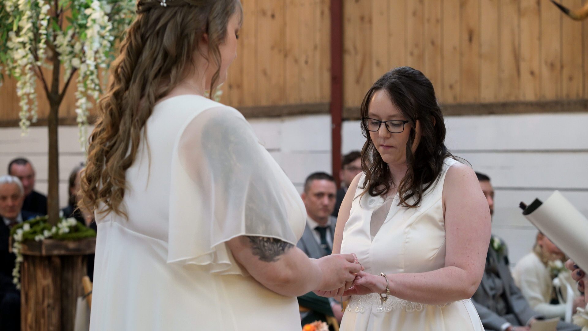 brides exchange rings during ceremony at the wellbeing farm in Bolton Lancashire