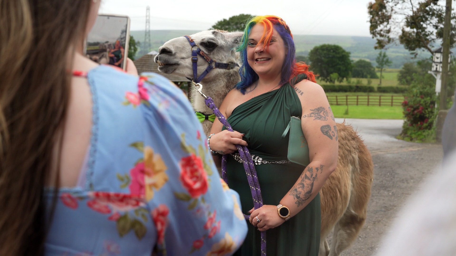 a guest laughs and poses with Ezra the Llama at the wellbeing farm in Bolton Lancashire