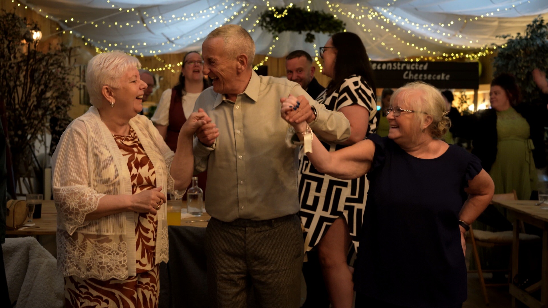guests hold hands and sing along during the meal at the wellbeing farm in Bolton Lancashire