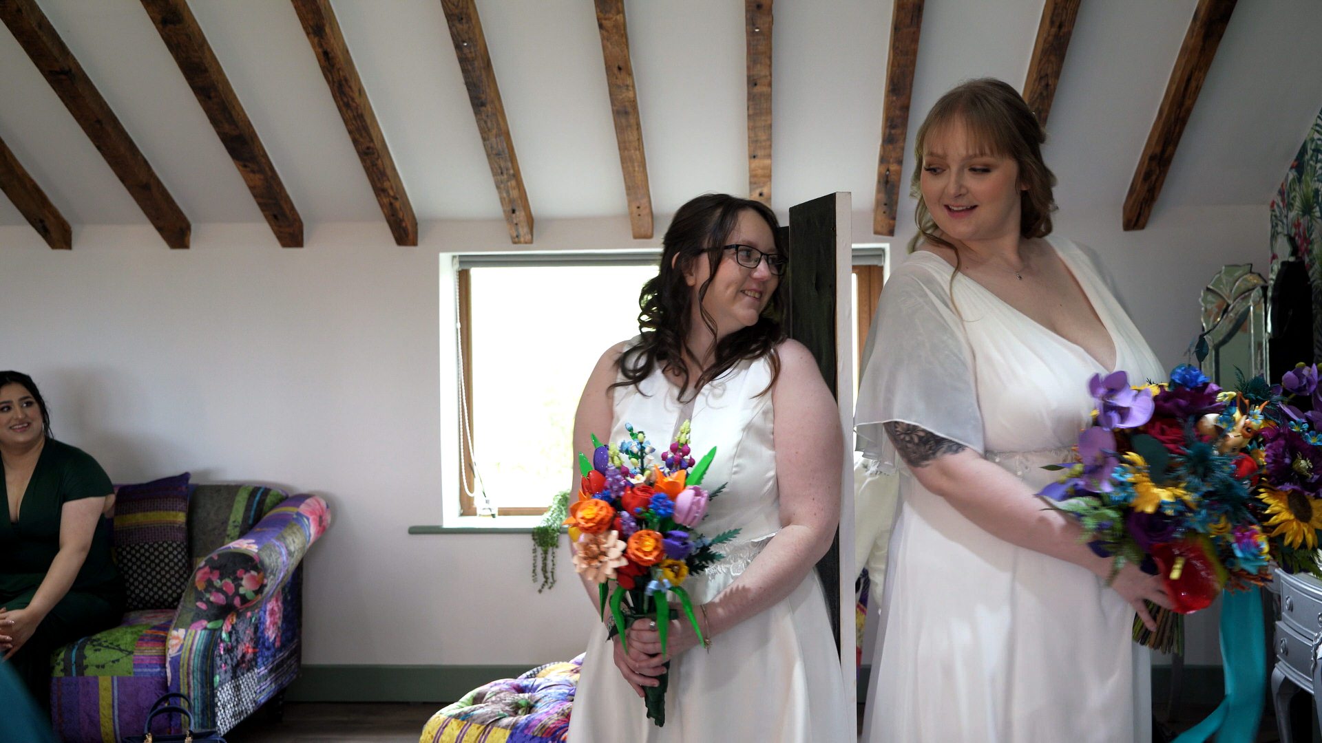 two brides enjoy a first look holding custom lego and pokemon wedding bouquets at the wellbeing farm in Bolton Lancashire