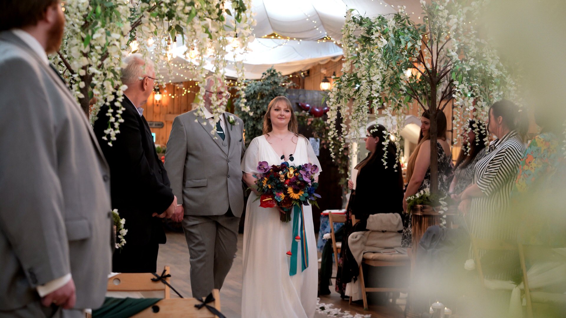 the first bride walks down the aisle with her dad at the wellbeing farm in Bolton Lancashire