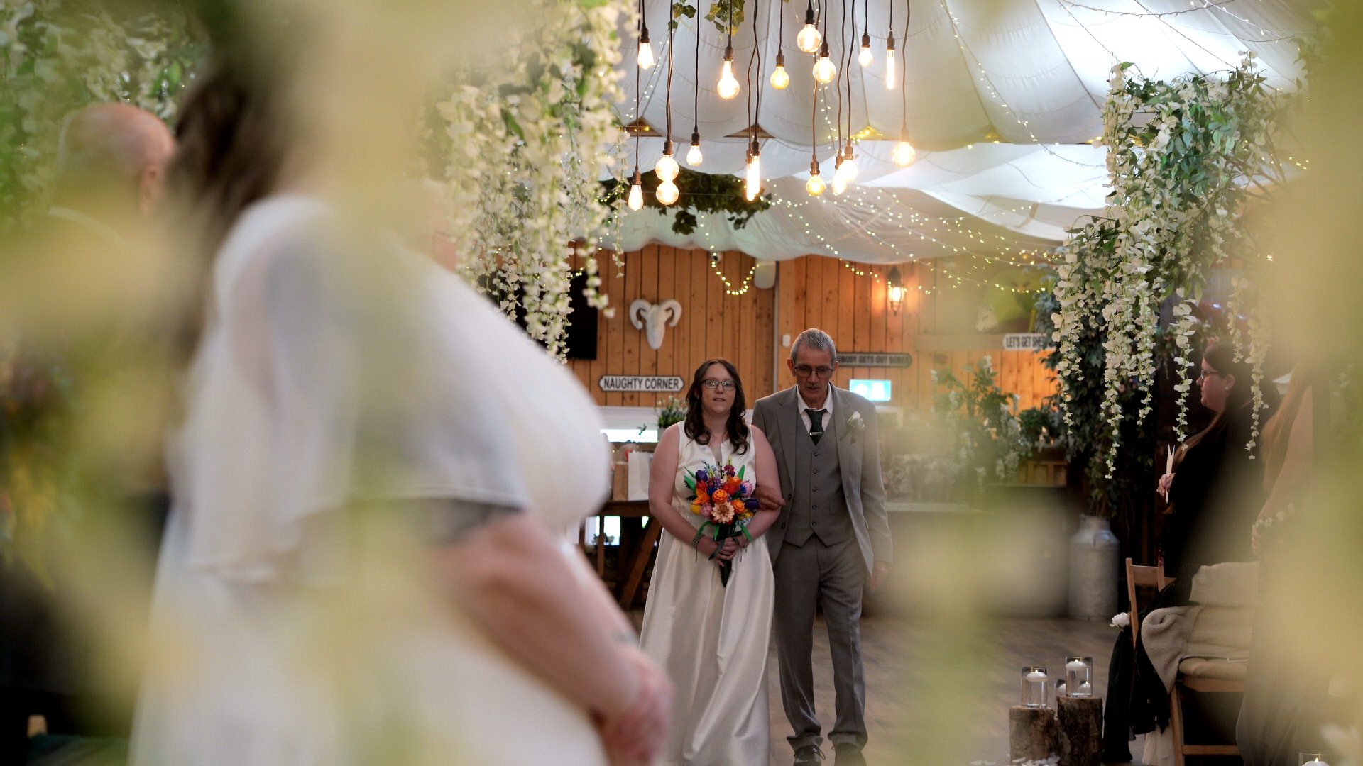 the second bride walks down the aisle with her dad at the wellbeing farm in Bolton Lancashire