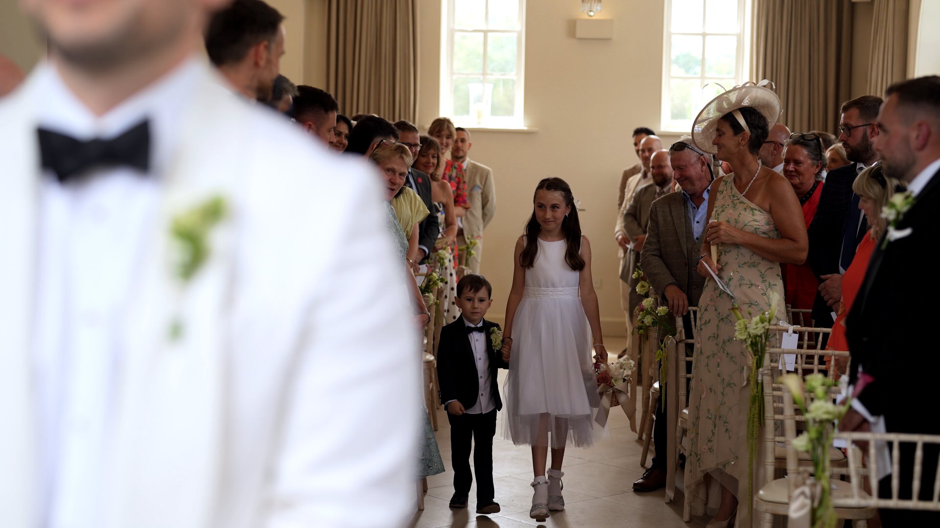 flowergirl and pageboy walk down the aisle