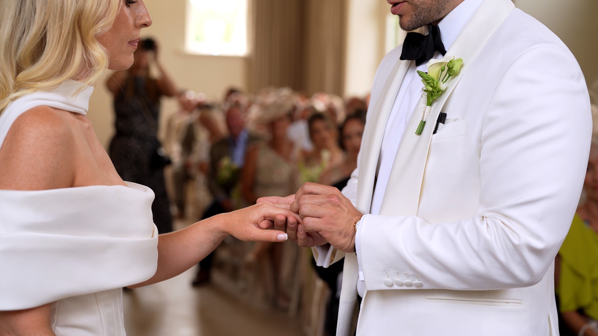 a close up of the couple exchanging wedding rings