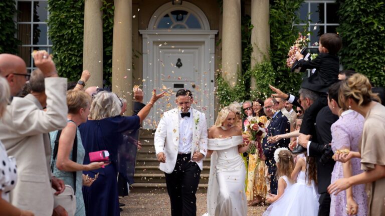 videographer captures the fun of a natural petal wedding confetti outside at Iscoyd Park