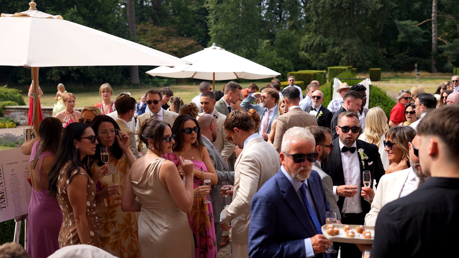 guests enjoy a drinks reception outside at Iscoyd Park