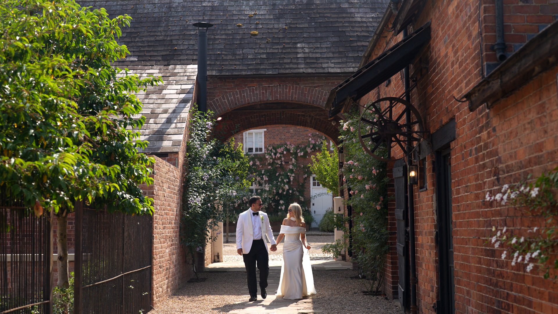 the couple stroll through the gardens at Iscoyd Park