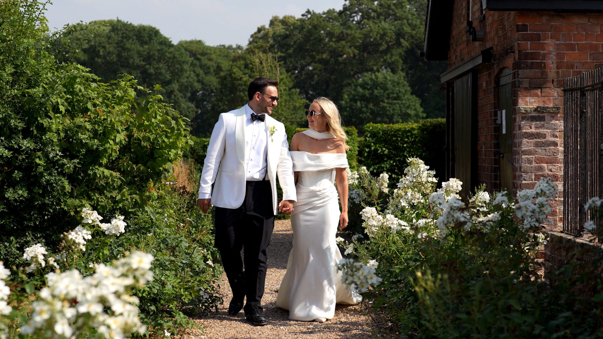 a relaxed summer portrait of a couple in black tie walking at Iscoyd Park