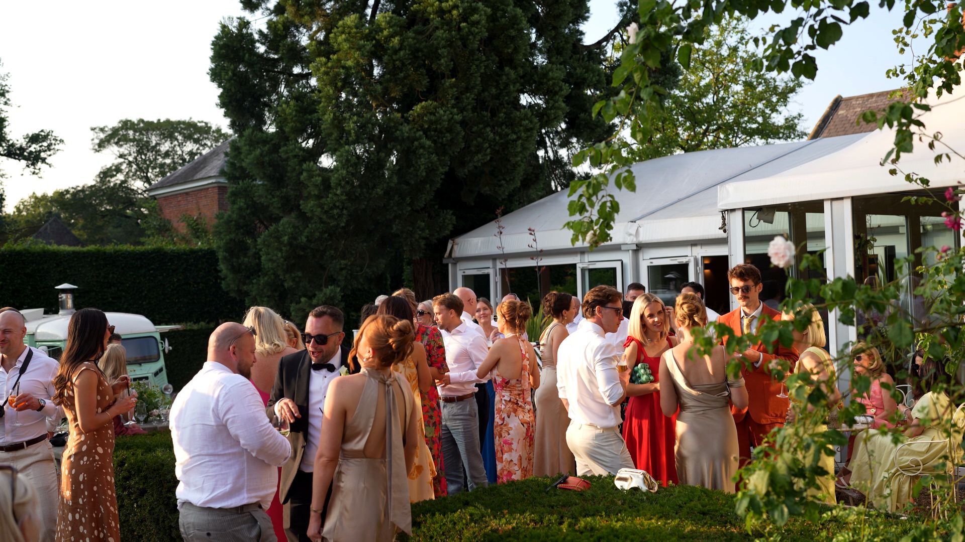 a wide shot of guests enjoying the drinks reception and pizza van outside at Iscoyd Park
