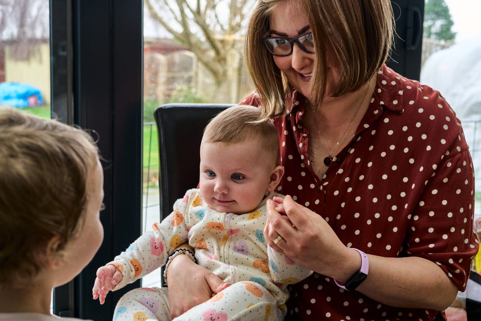 a candid moment of a mum with her children