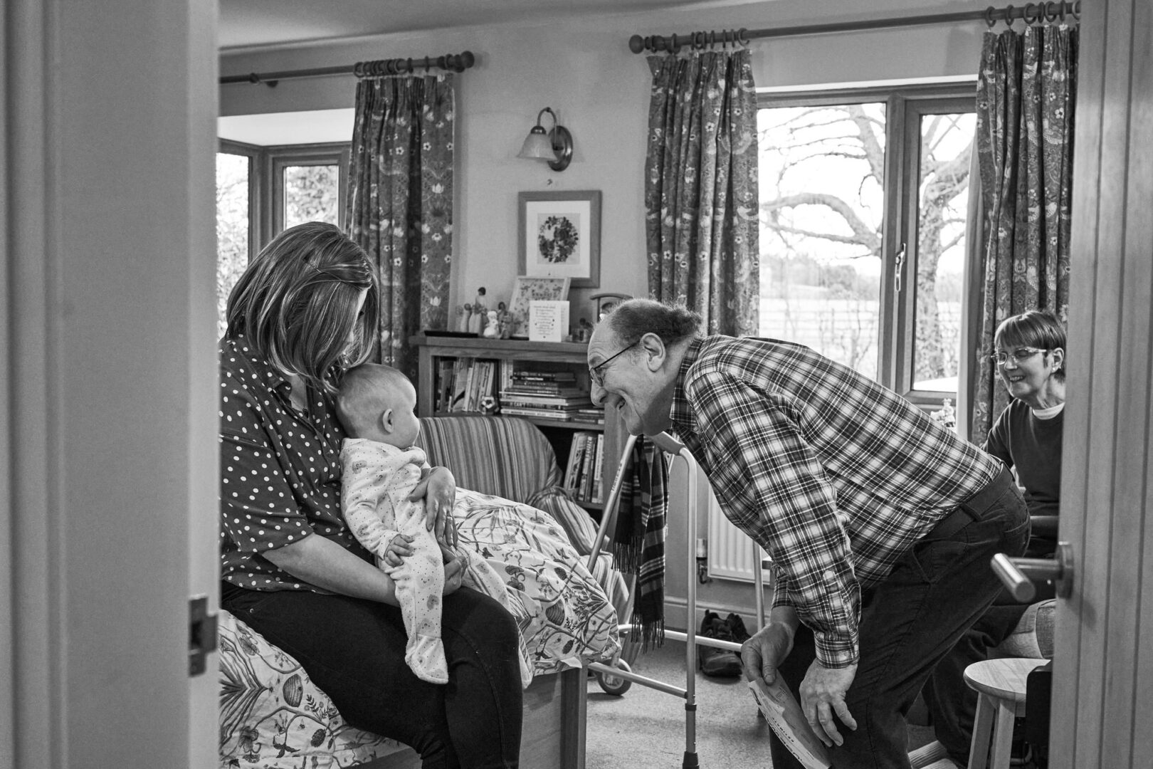 a natural photo taken of a grandad with his daughter and grandchild